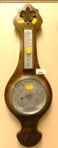 An oak aneroid mercury barometer.