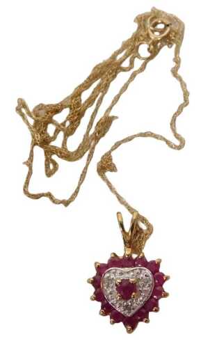 A 9ct gold ruby and diamond heart shaped pendant, on a fine link neck chain, yellow metal,...