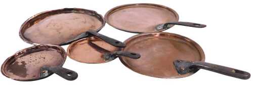 A set of five vintage graduated copper saucepan lids, with cast iron handles.