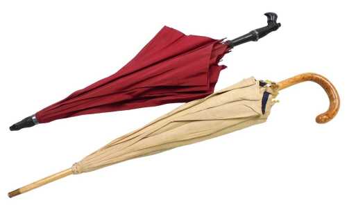 An early 19thC Bakelite umbrella, the handle formed as a clog and stocking with metal garter,...