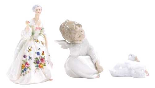 A Lladro porcelain figure of a cherub, modelled seated in reflection, a Nao porcelain figure of...