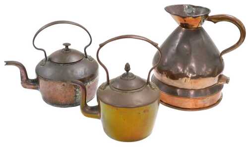 An early 20thC two gallon copper jug with heater, together with two copper kettles. (3)