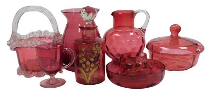 A group of Victorian and later cranberry glass, including a basket, water jug, powder bowl and...