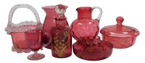A group of Victorian and later cranberry glass, including a basket, water jug, powder bowl and...