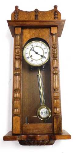 A late 19thC oak cased wall clock, circular brass dial with enamel chapter ring bearing Roman...