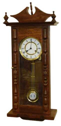 A late 19thC oak cased wall clock, circular brass dial with enamel chapter ring bearing Roman...