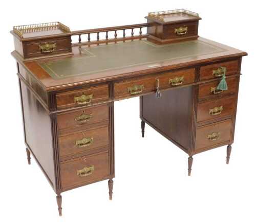 A Victorian mahogany twin pedestal desk, the top inset with gilt tooled green leather, with a...
