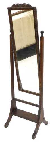 An early 20thC oak cheval mirror, the rectangular swing frame mirror plate within a gadrooned...