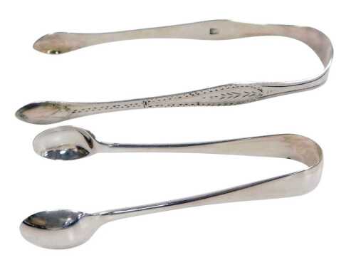 A pair of Georgian silver sugar tongs, with stipple engraving, and a pair of Victorian silver...