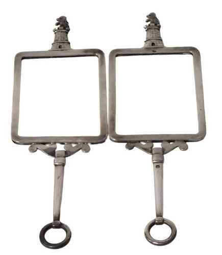 A pair of 19thC French handheld silver frames, surmounted by a castle and rampant lion crest,...