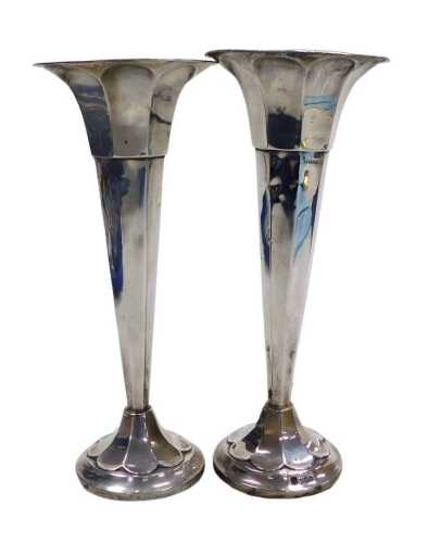 A pair of George V loaded silver bud vases, of octagonal trumpet form, raised on circular bases,...