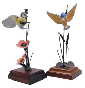 Two Danbury Mint painted bronze bird sculptures, by David Shire, each raised on a wooden base,...