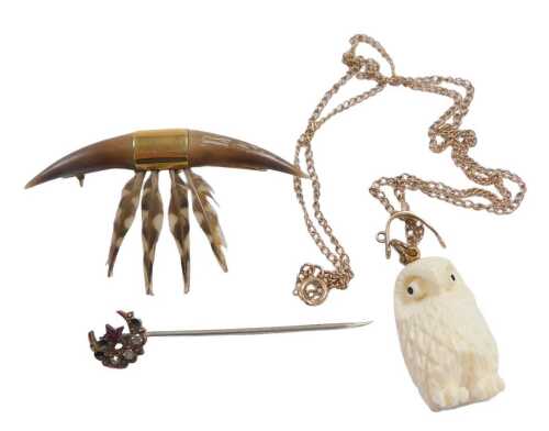 A horn and feather brooch, mounted in yellow metal, stamped 15ct, a Victorian tie pin, of star...
