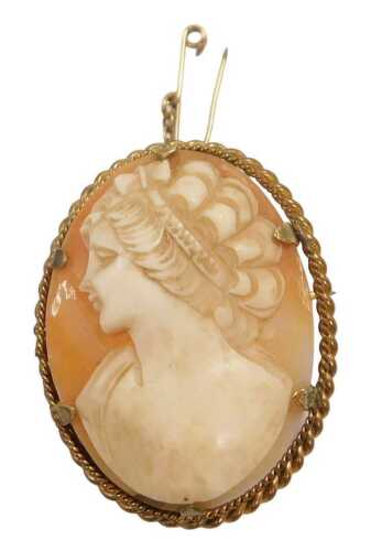 A shell cameo brooch, bust portrait of a lady facing left, in a yellow metal mount, with safety...