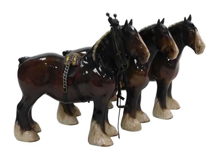 Three Beswick pottery figures of Shire horses, one with hame and harness, printed marks.