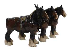 Three Beswick pottery figures of Shire horses, one with hame and harness, printed marks.