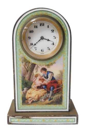An early 20thC brass and enamel table clock, circular enamel dial bearing Arabic numerals,...