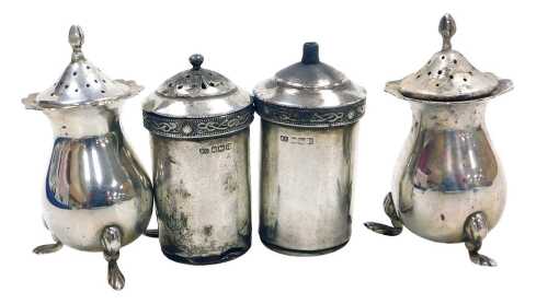A pair of George V silver pepperettes, raised on three paw feet, Birmingham 1924, 2.73oz.
