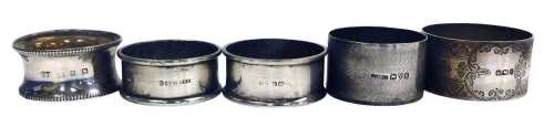 Five Victorian and silver napkin rings, plain or with engine turned and engraved decoration,...