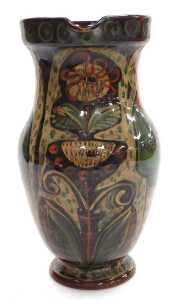 A late 19th/early 20thC pottery jug, possibly Scandinavian, painted with a man holding a goose... - 2