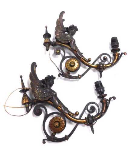 A pair of late 19thC copper and brass wall sconces, each cast with the bust of an angel, and...