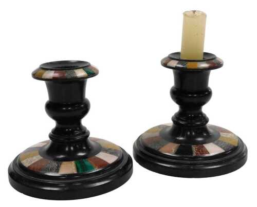 A pair of late 19thC Derbyshire black marble and pietra dura candlesticks, 10.5cm high.