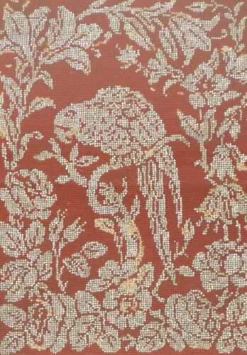 A Victorian mahogany framed wool and beadwork panel, depicting a parrot perched on a branch, in...