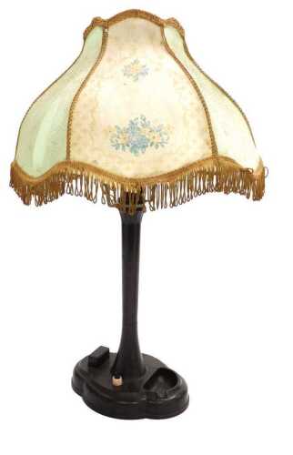 An early 20thC Bakelite table lamp, with an integral matchbox holder and ashtray, with a printed...