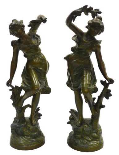 A pair of late 19thC French patinated spelter figures of ladies, modelled in standing pose, one...