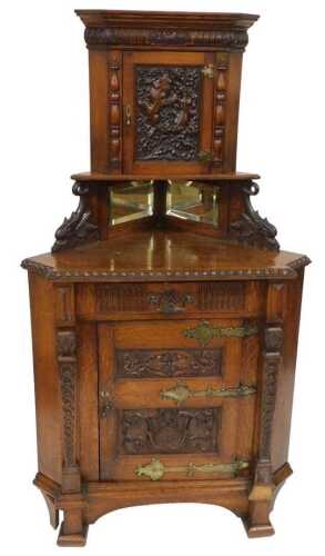 A Victorian Renaissance Revival oak corner cupboard, the outswept pediment above an oval...