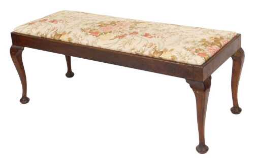 A George III mahogany duet stool, with a floral fabric seat, raised on cabriole legs, on pad...