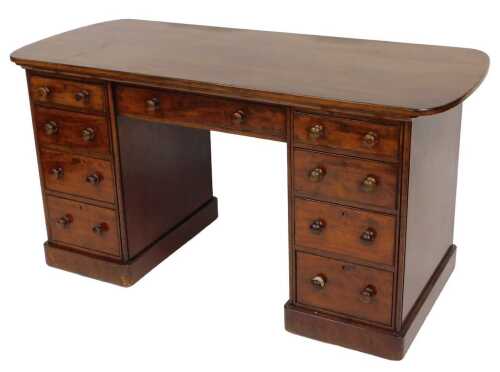 A Victorian mahogany twin pedestal desk, with one long drawer flanked by eight graduated drawers,...