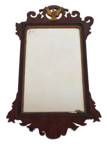 A George III mahogany fretwork wall mirror, with a carved pediment and centred on a giltwood...