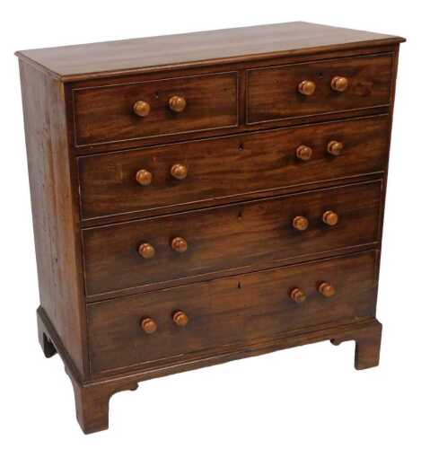 A George III mahogany chest, of two short over three long graduated drawers, with later turned...