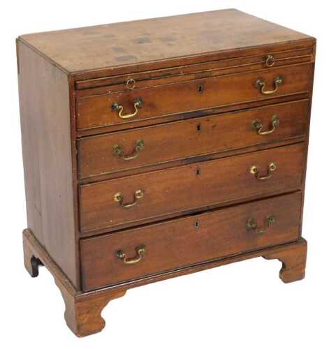 A George III mahogany bachelor's chest, with a brushing slide over four long graduated drawers,...