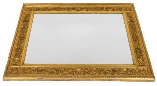 An early 19thC giltwood wall mirror, carved with a basket of fruit, urns of flowers, and foliate...