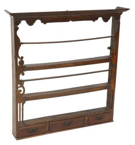 A Georgian oak plate rack, with an outswept pediment over two shelves, the base with three...