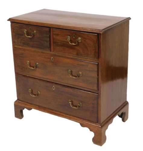 A George III mahogany chest, of two short over two long graduated drawers, raised on bracket...
