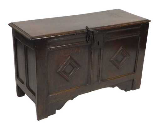 An early 18thC oak coffer, with a triple panel front, raised on stiles, 63cm high, 107cm wide,...