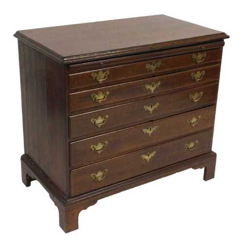 A George III oak bachelor's chest, with a brushing slide over five long graduated drawers,...