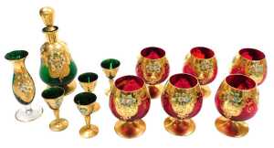 A set of six Murano ruby glass brandy balloons, overlaid with enamelled flowers and gilding,...