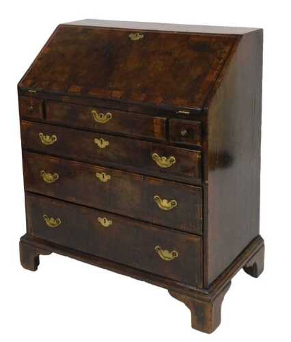 An early 18thC Georgian mahogany and crossbanded bureau, the fall flap opening to reveal a...