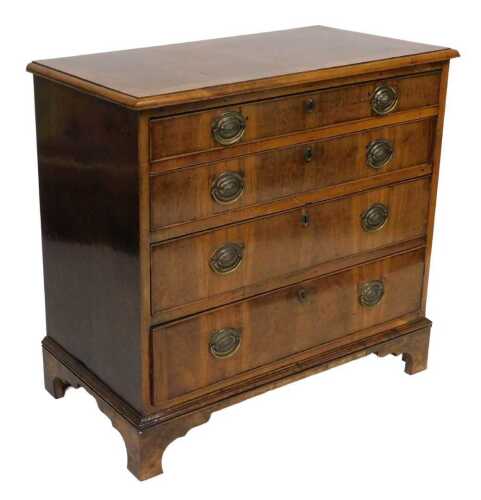 A George III walnut and herringbone cross banded chest, of four long graduated drawers, raised...
