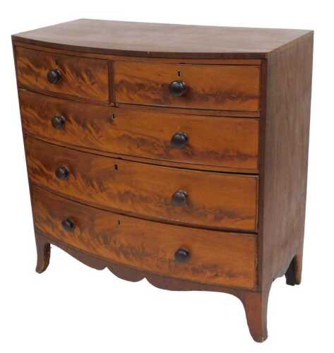 A Victorian mahogany chest, of two short over three long graduated drawers, raised on outswept...