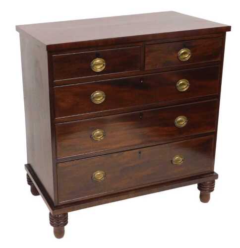 A late Georgian mahogany chest, of two short over three long graduated drawers, raised on turned...