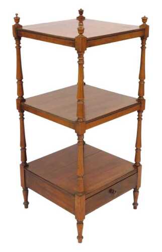 A Victorian mahogany three tier whatnot, raised on turned supports, above a frieze drawer, on...