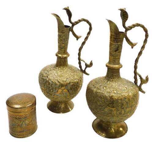 A pair of early 20thC Indian brass ewers, embossed with figures, animals, and scrolling leaves...