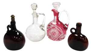 A Bohemian cranberry cut glass claret jug, with a clear glass stopper, 26cm high, further clear...