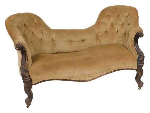 A Victorian rosewood two seater conversation sofa, with foliate carved scroll arms, upholstered...