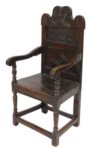 A 17thC oak wainscot chair, the shaped crest rail carved with a tree and flowers, above two...